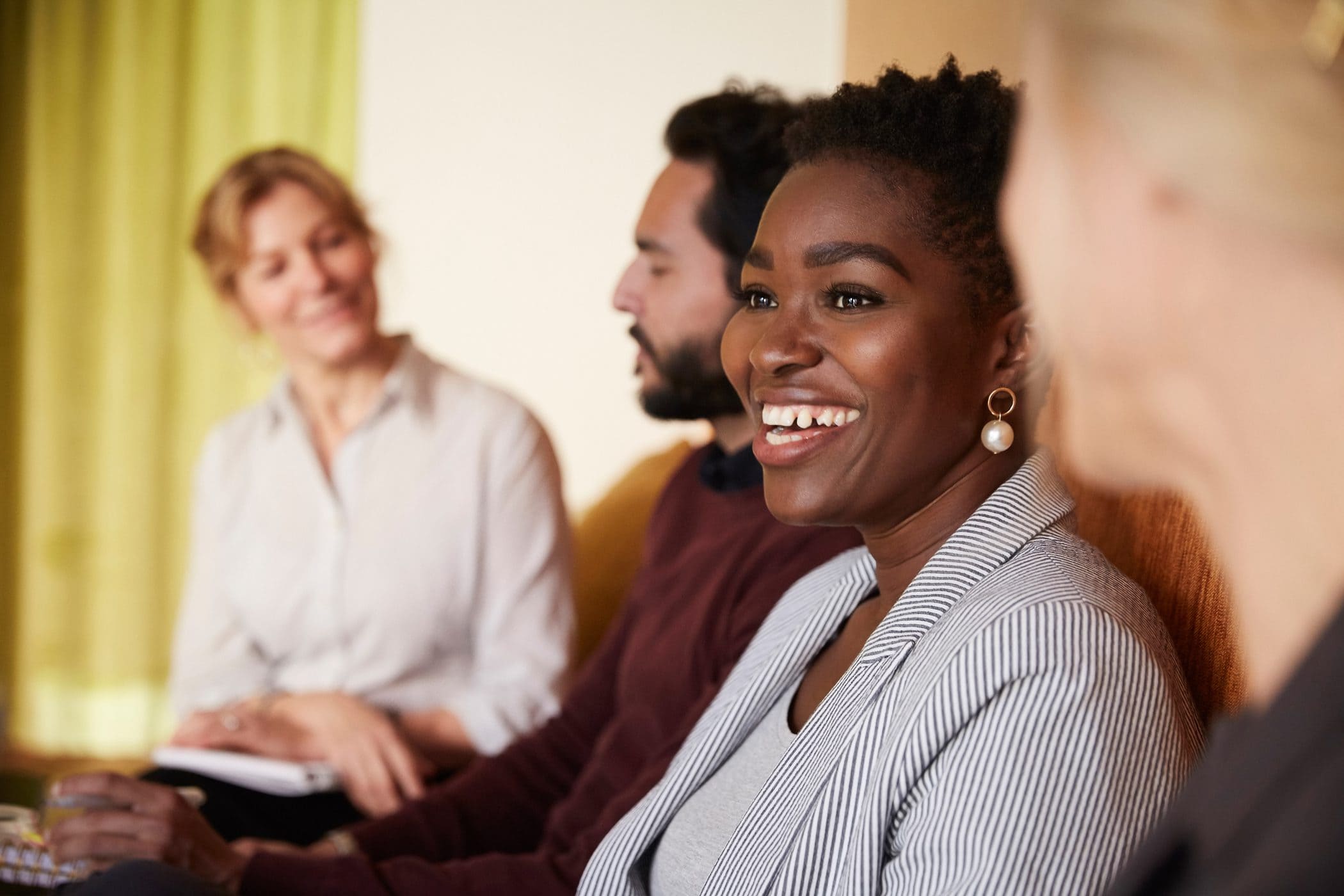 A women smiling in a conference room
